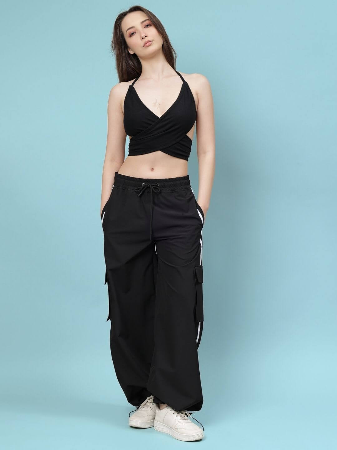 Model wearing Women's Xavier Relaxed Fit Multi-Pocket Cargo Pants in black, showcasing customizable fashion options.