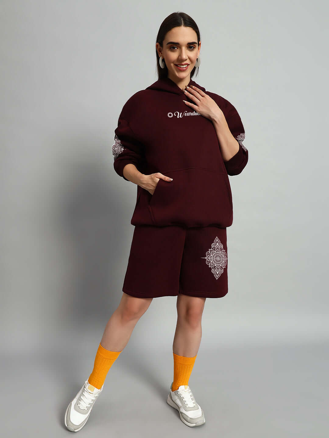 Woman wearing WOMEN'S YANTRA FLEECE CO-ORD SET WINE, featuring cozy fleece fabric and modern streetwear appeal, styled for casual comfort.