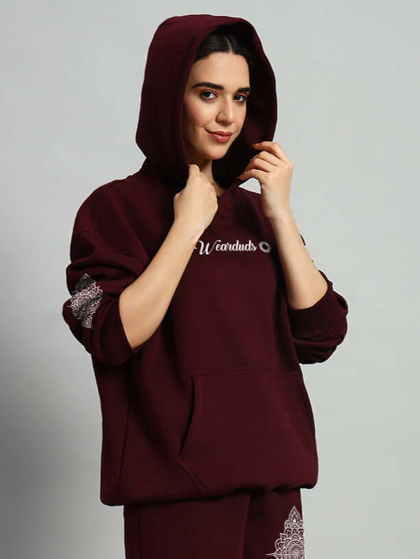Woman wearing WOMENS YANTRA FLEECE HOODIE WINE in deep wine color