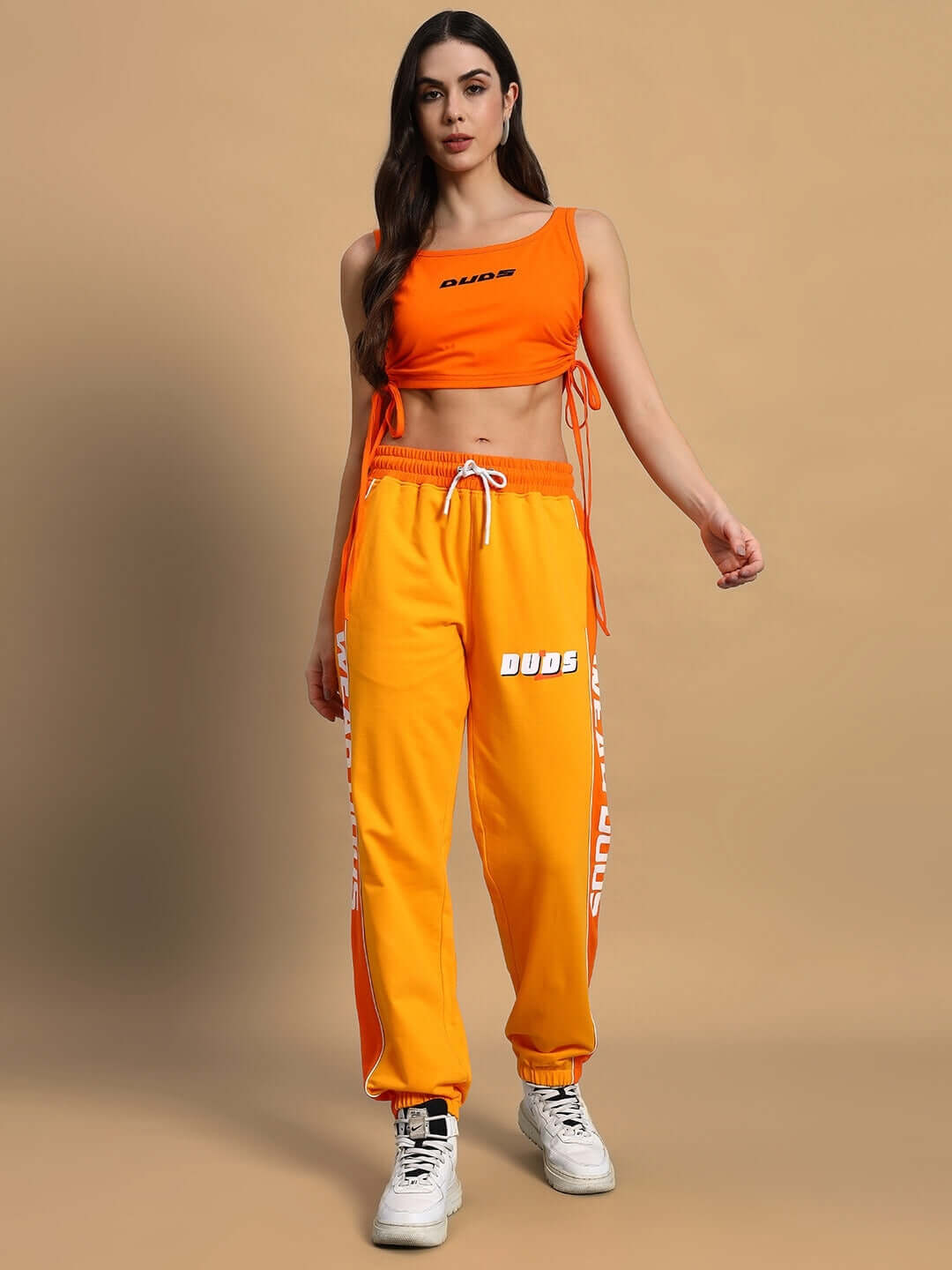 Model wearing women's yellow-orange Squeeze Co-Ord set with print, featuring premium cotton French terry lycra, elastane blend, India-made.