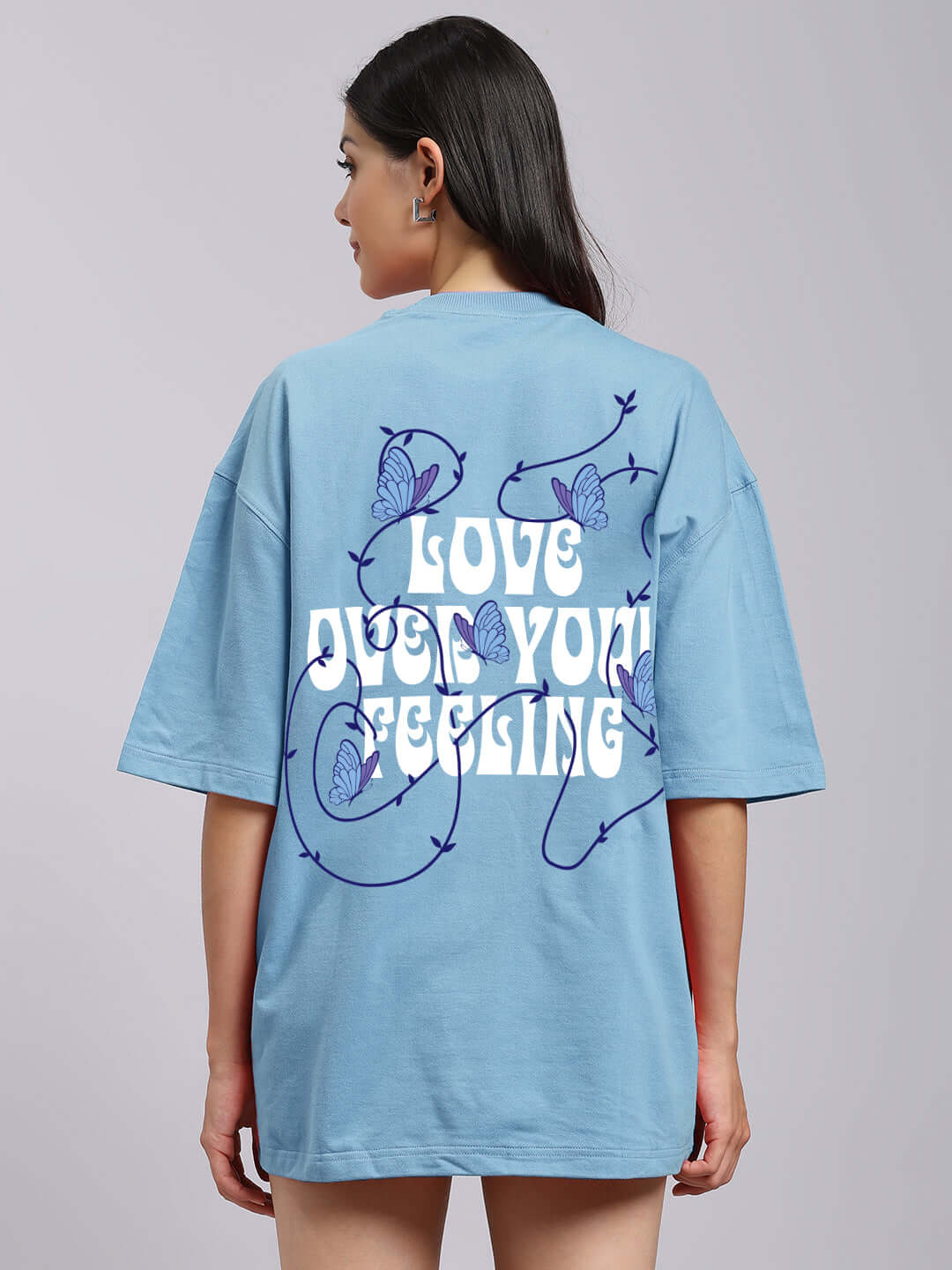 Sky blue women's t-shirt with 'Love Out Your Feeling' text and butterfly design on the back, made from premium cotton blend.