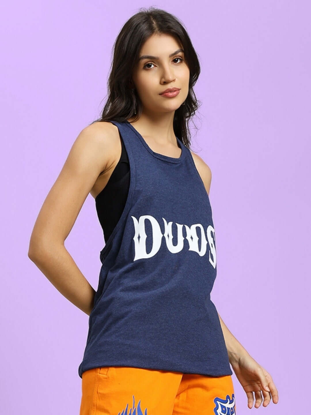 Alt Tag: Woman wearing blue WOMEN'S ZEMPA FITNESS GYM T-SHIRT with DUDS logo, styled with vibrant orange bottoms.