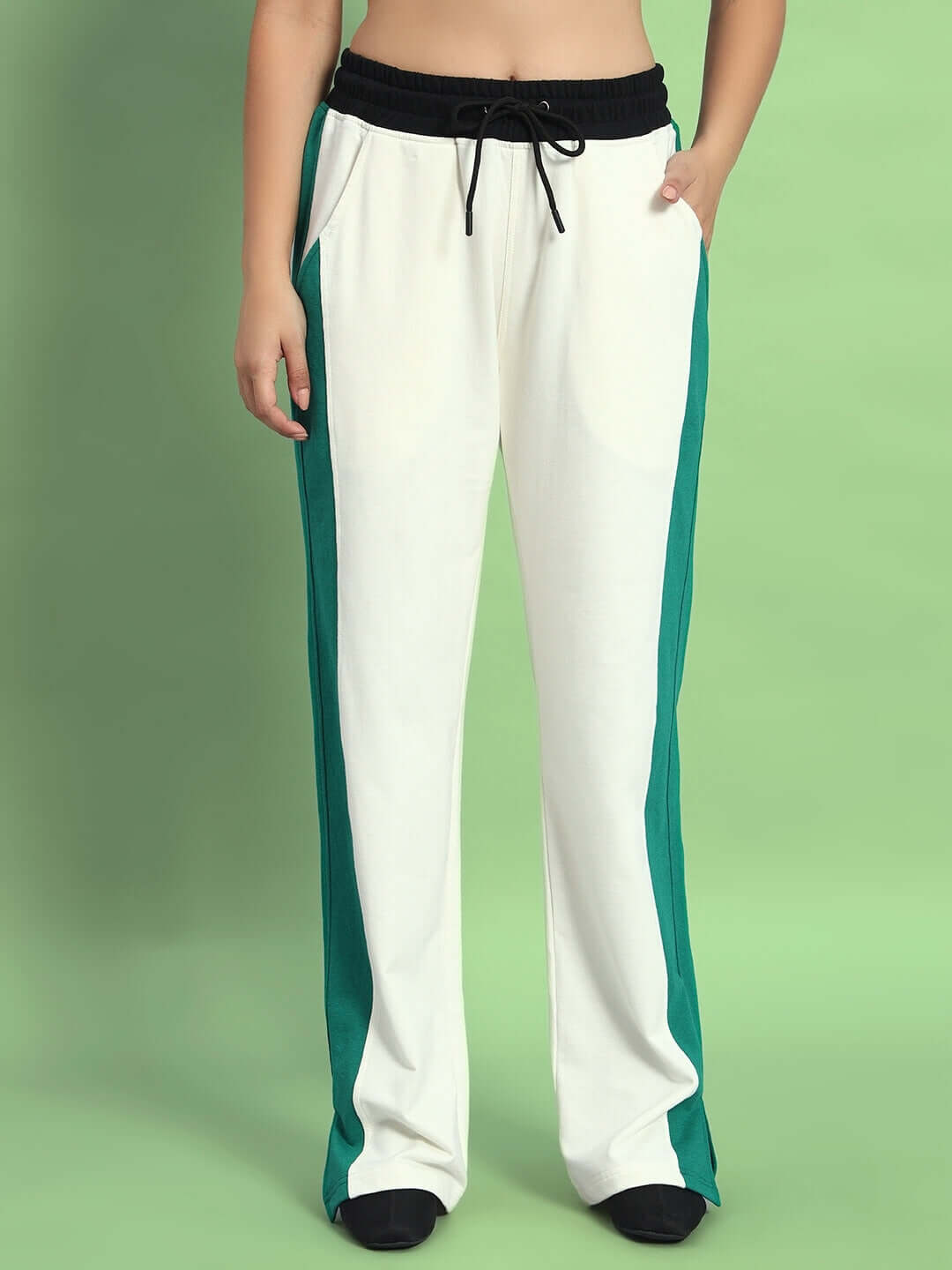 Woman wearing off white and teal joggers from DUDS, showcasing a comfortable fit with black drawstring waistband, perfect for casual wear.