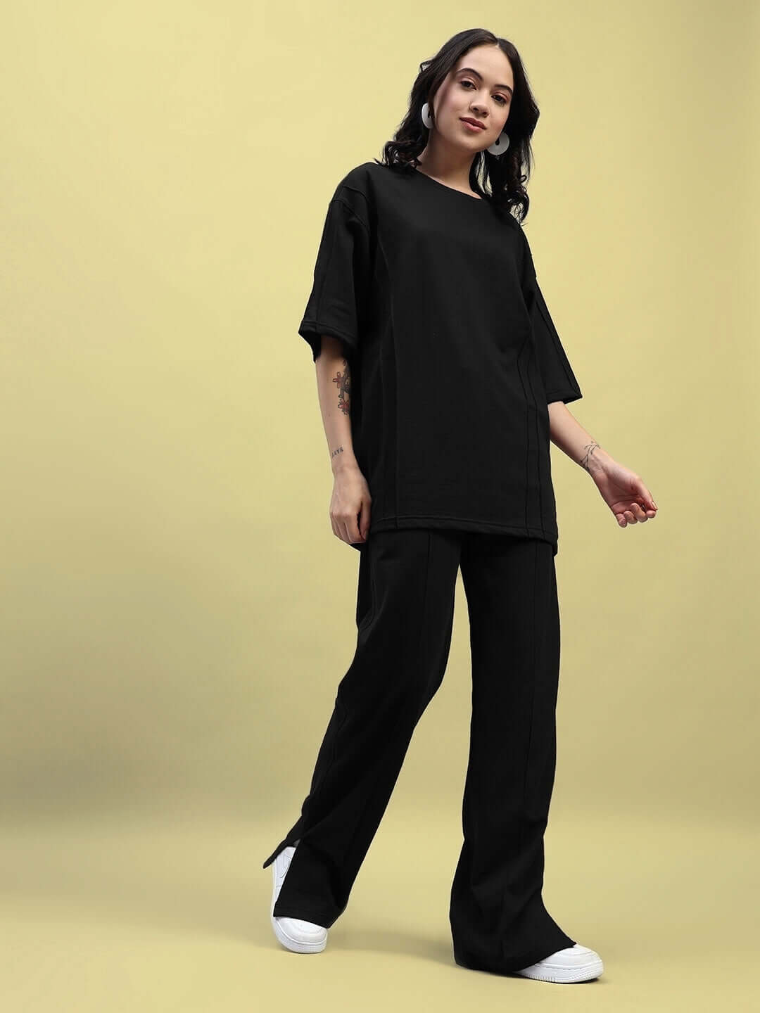 Model wearing Women's Zion Relaxed Fit Co-ord Set in black, featuring a premium cotton t-shirt and elasticated joggers, ideal for casual wear.