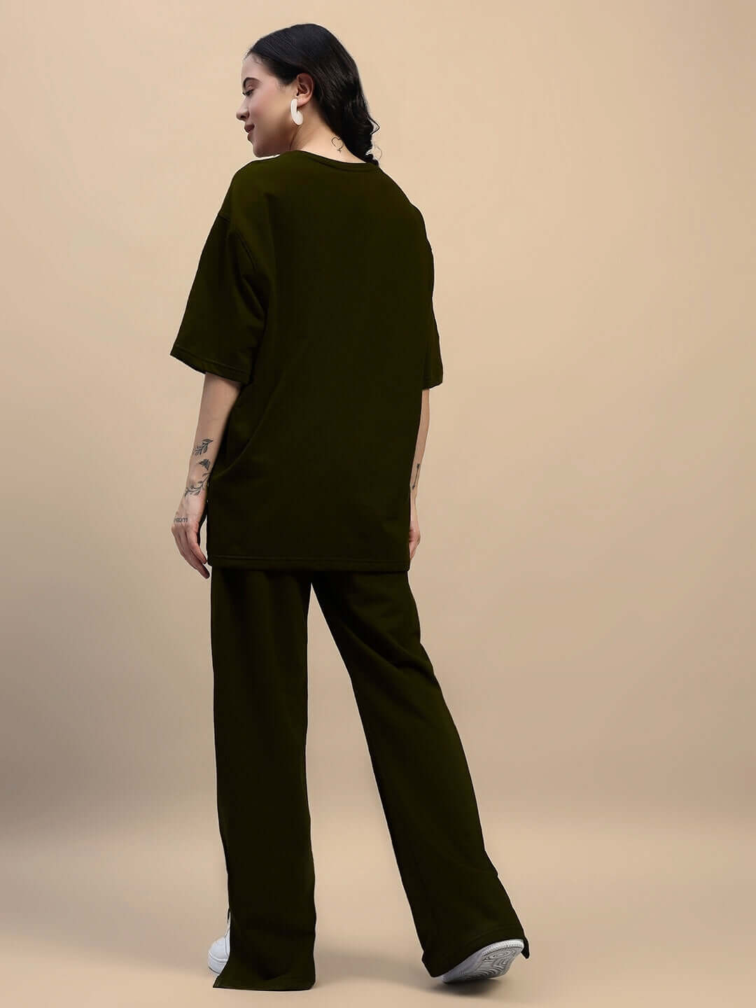 Woman wearing olive green relaxed fit co-ord set with elasticated waistband joggers.
