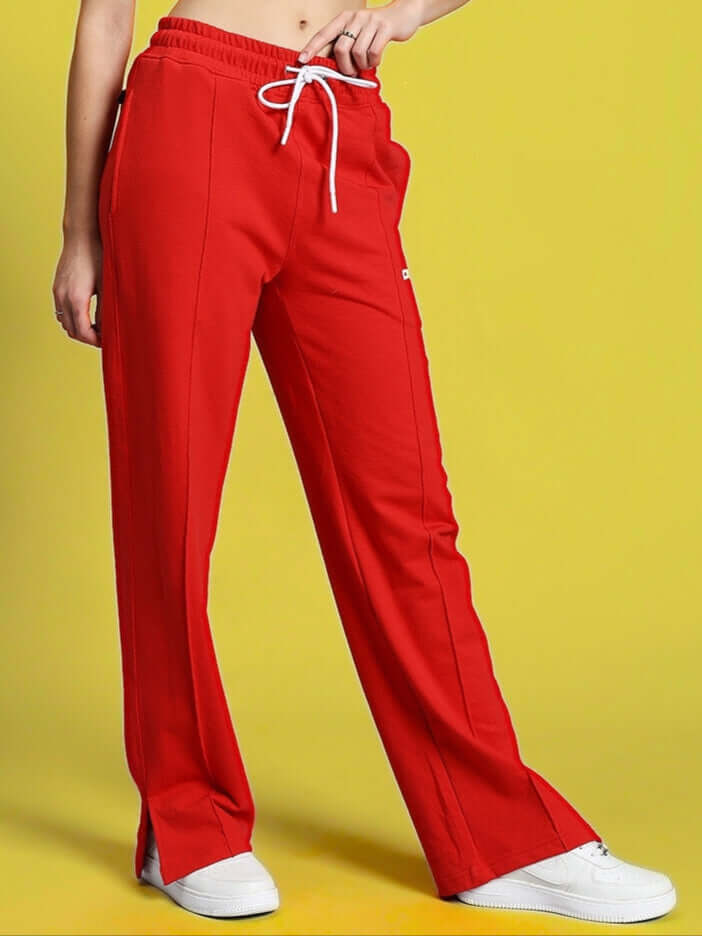Model wearing Women's Zion Side Slit Joggers in Red, showcasing comfortable fit and design with white sneakers.