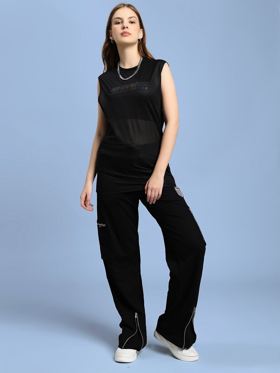 Model wearing WOMEN'S ZIP TECH PREMIUM CARGO BLACK pants, showcasing tactical design and modern functionality in sleek black.