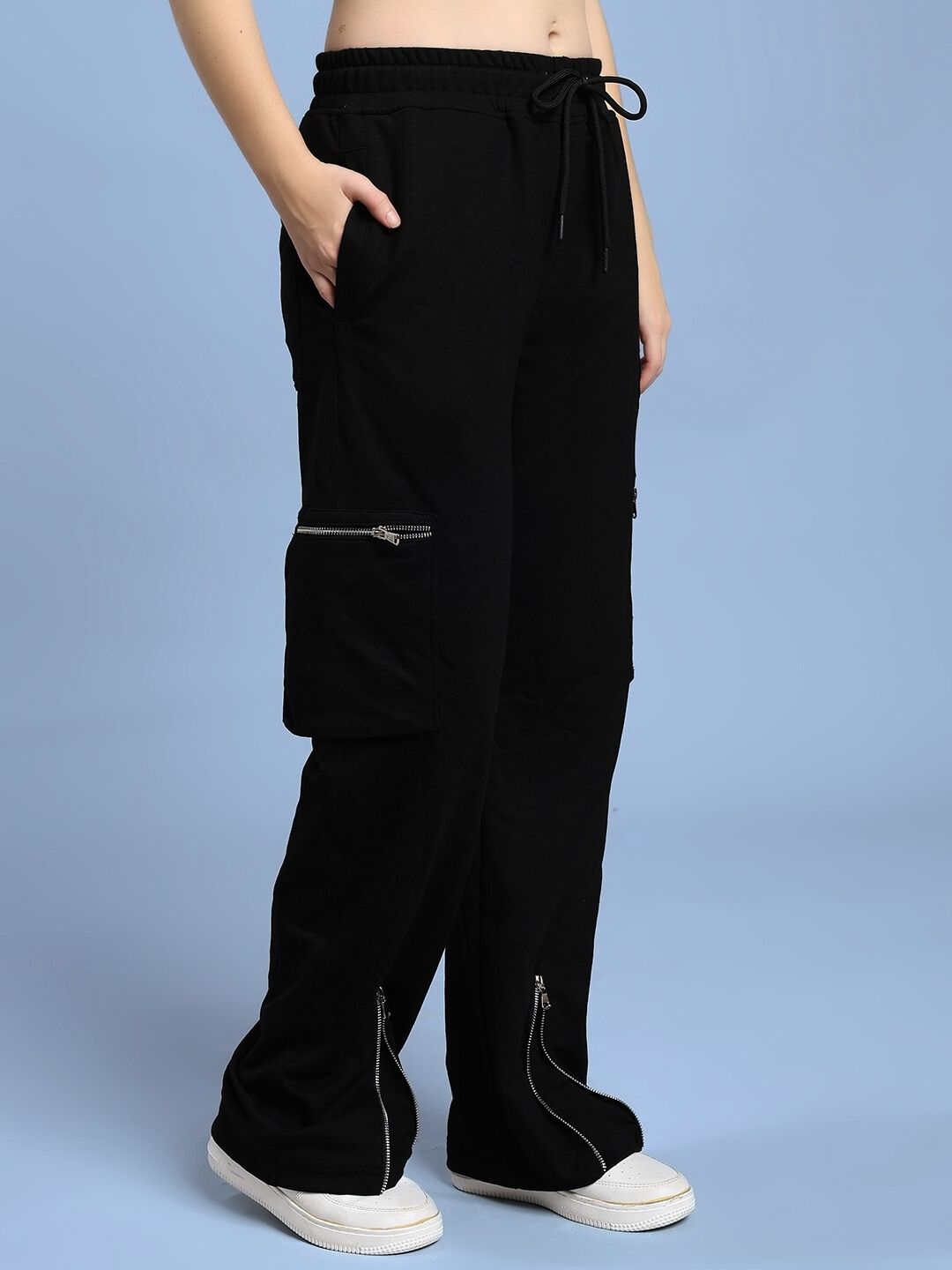 Model wearing WOMEN'S ZIP TECH PREMIUM CARGO BLACK pants with sleek black design and water-resistant fabric.