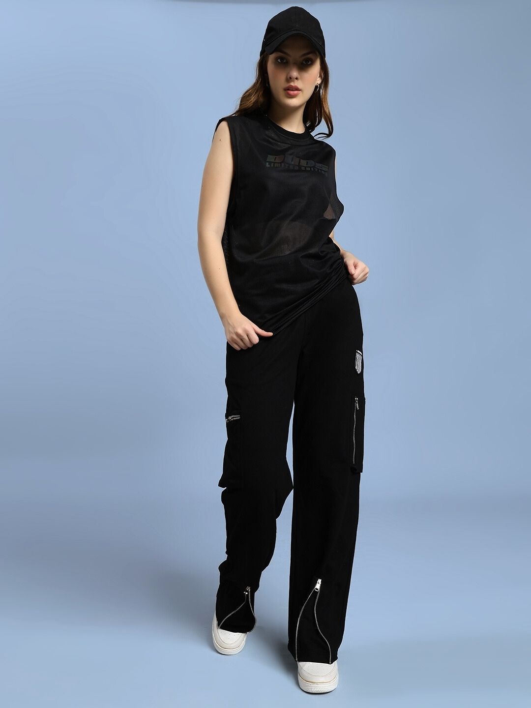 Model wearing WOMEN'S ZIP TECH PREMIUM CARGO BLACK pants with water-resistant fabric, blending utility and style for urban adventures.