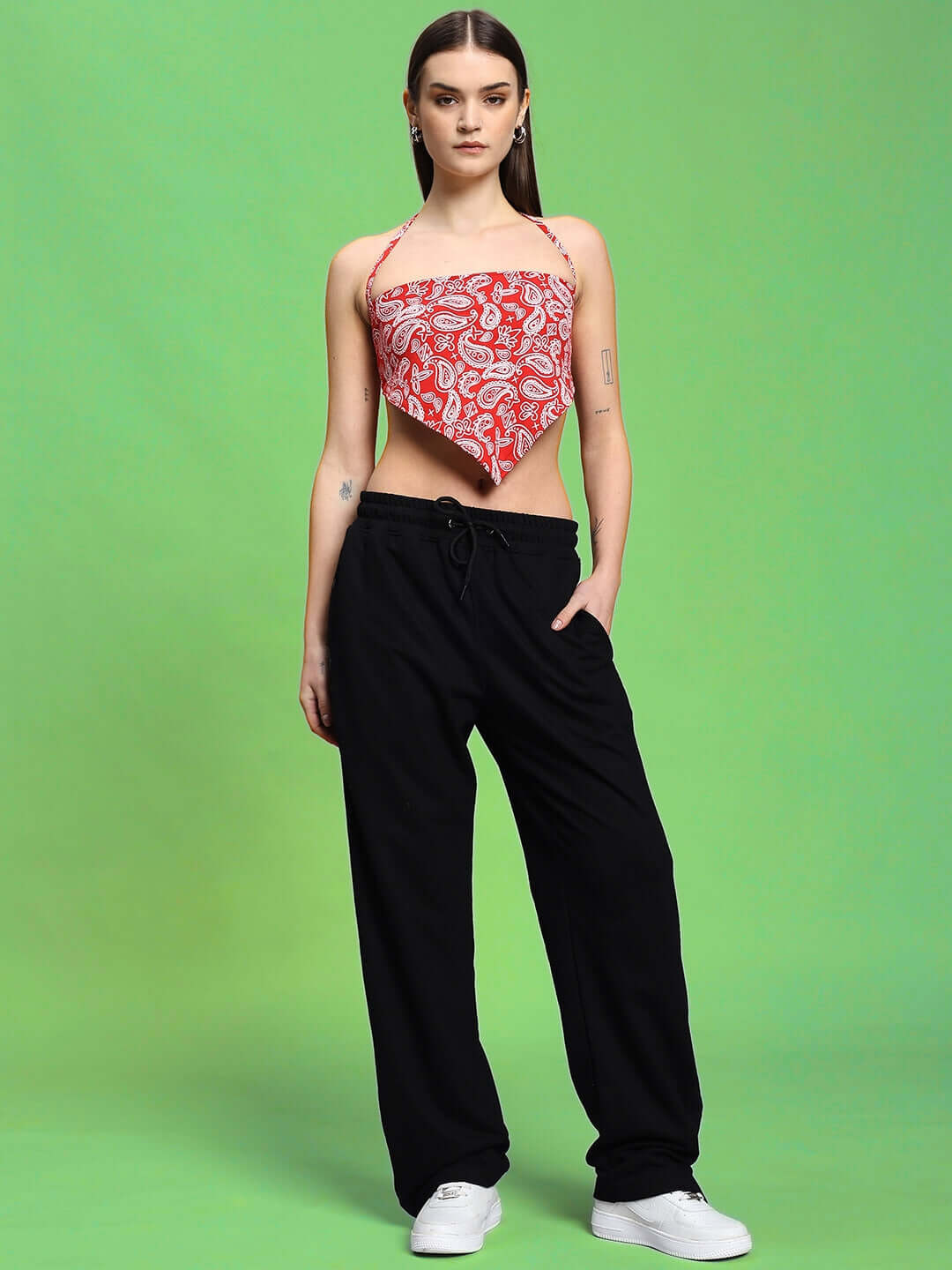 Model wearing WOMEN'S ZIVA CO-ORD SET RED-BLACK featuring a red patterned top and black pants, showcasing bold and casual elegance.