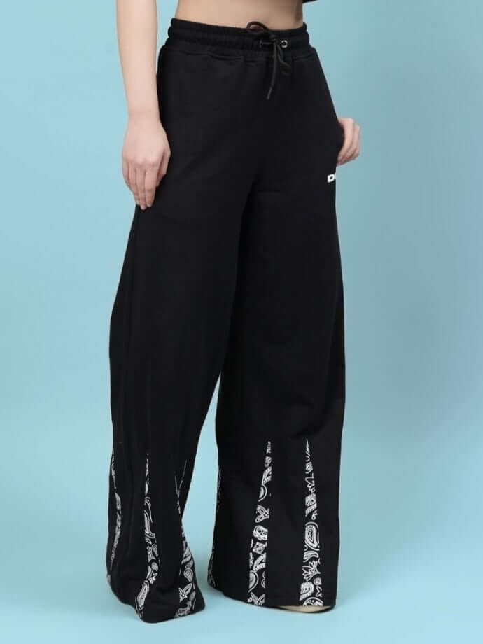 Alt Tag: Women's Ziya baggy joggers in black featuring a relaxed fit with unique printed accents, designed for custom fit by DUDS tailors.