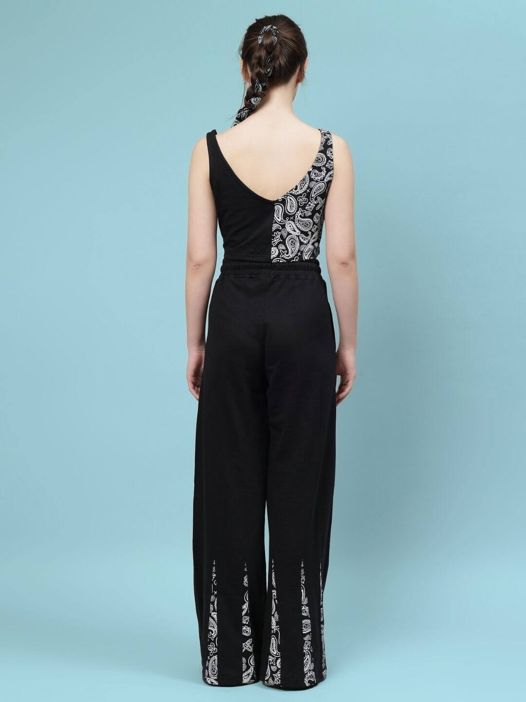 Woman wearing a black Ziya co-ord set with patterned details, featuring a sleeveless top and wide-leg pants, viewed from the back.