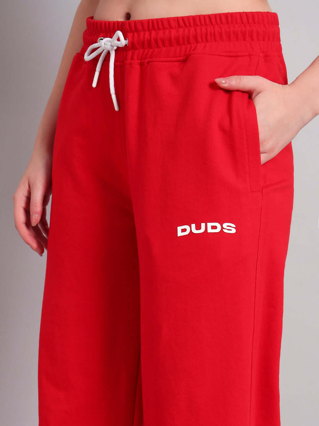 Close-up of WOMENS AUSTRIAN RELAXED-FIT JOGGERS RED with elastic waistband and side pocket, showcasing sporty and comfortable style.