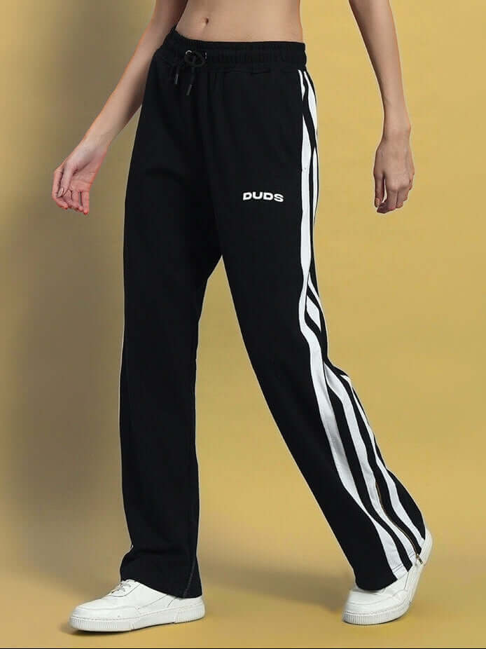 Women's Avalon Slit Zipper Joggers in Black-White by DUDS, featuring custom fit options and white stripes, paired with sneakers.