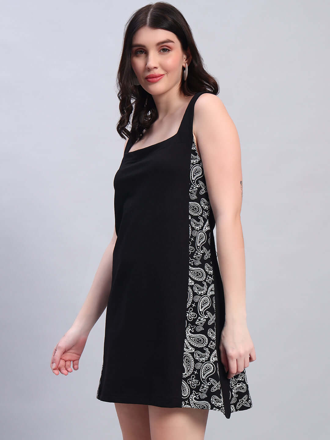 Woman wearing black women's Kudos dress with paisley detailing, made of polyester and spandex, ideal for versatile styling.