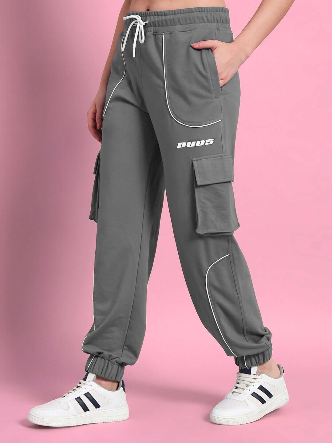 Women's Devino Relaxed-Fit Grey Joggers by DUDS with cargo pockets, shown on model against pink background, featuring a casual fit.
