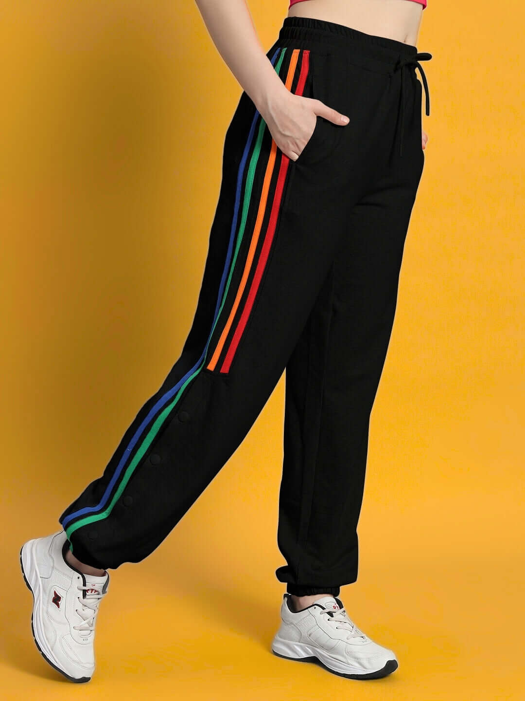 Women's DUDS Prism joggers in black with colorful side stripes, showcased on a model. Ideal for custom fit orders. Dispatch in 7-10 days.