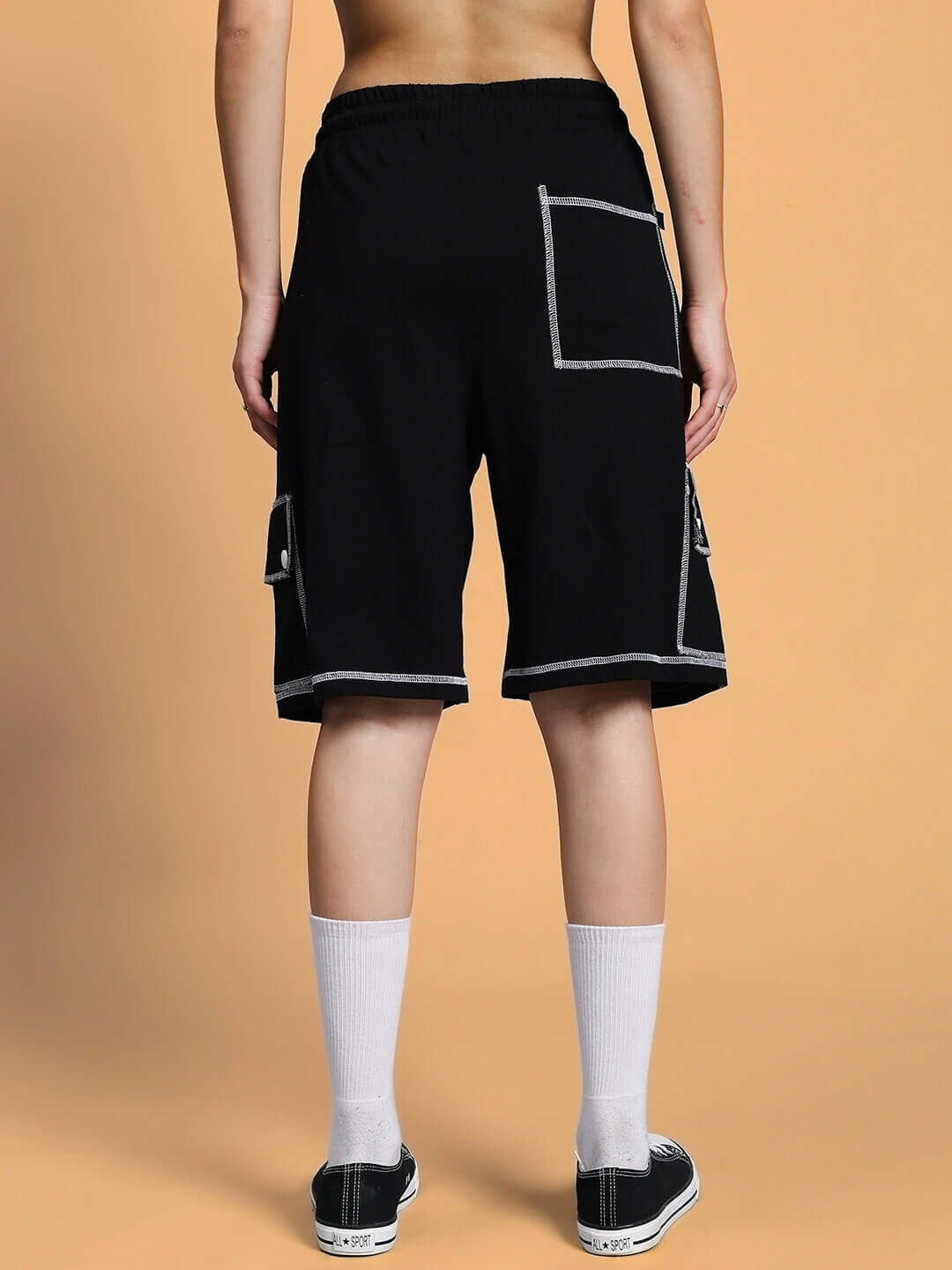 Woman wearing black summer co-ord set with white contrast stitching, featuring premium cotton and Lycra fabric, styled.