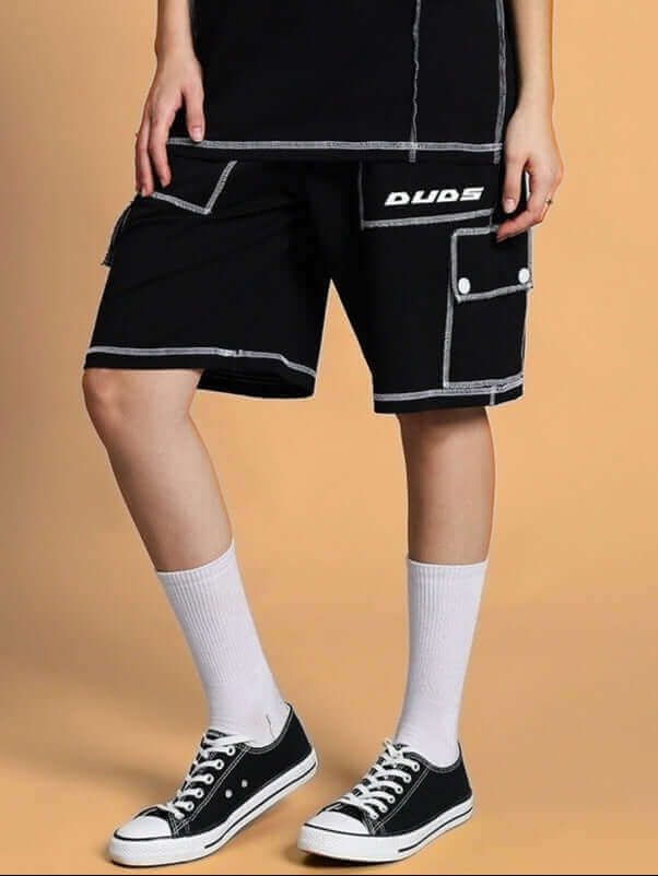 Black women's summer co-ord set with shorts and contrasting white stitching, featuring a sporty design with knee-length socks and sneakers.