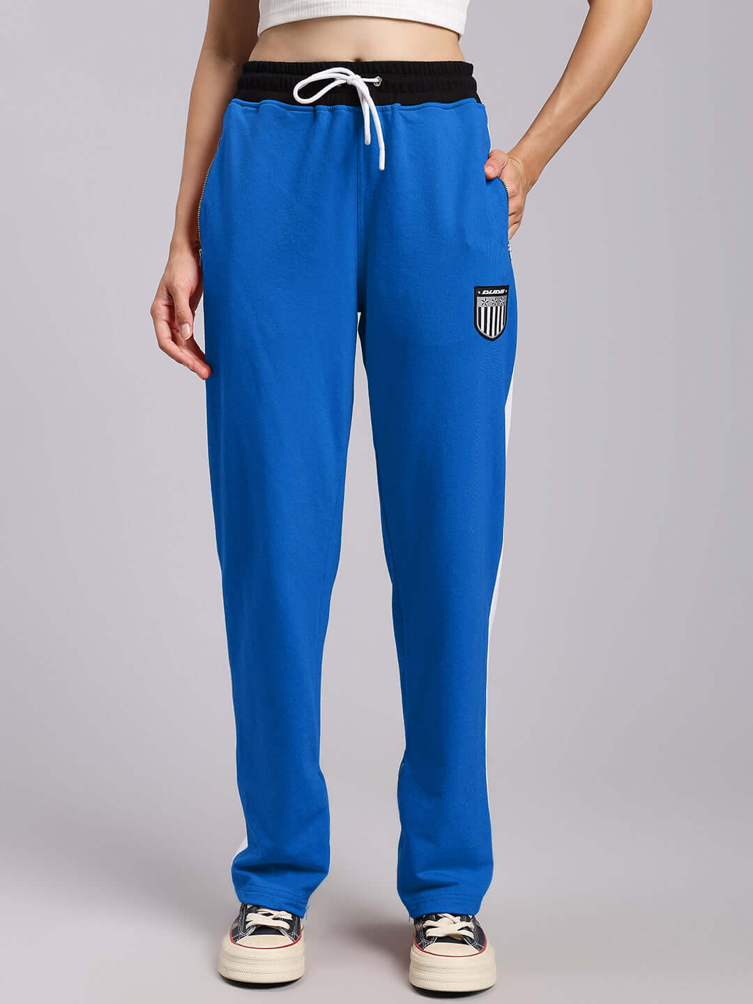 Women's elegant relaxed-fit joggers in blue with drawstring waistband and patch detail, made to order by DUDS.