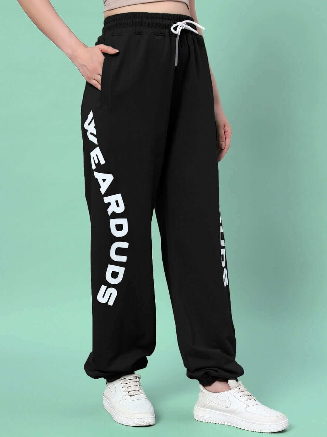 Model wearing Women's Ellen Relaxed Fit Jogger in black featuring custom fit option and WEARDUDS branding, made to order by DUDS.