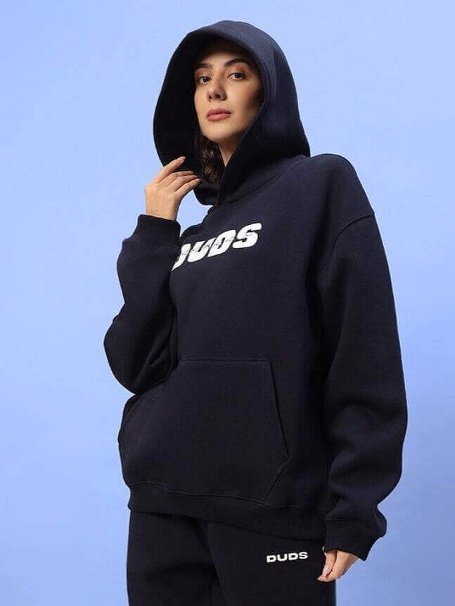 Woman wearing navy blue Fight Night fleece co-ord, featuring a hoodie and joggers.