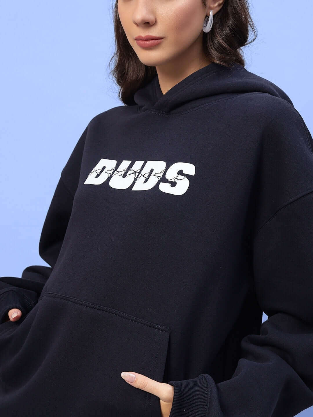 Navy blue Women's Fight Night Fleece Co-ord with hood, featuring bold 'DUDS' text on front, modeled against a light blue background.