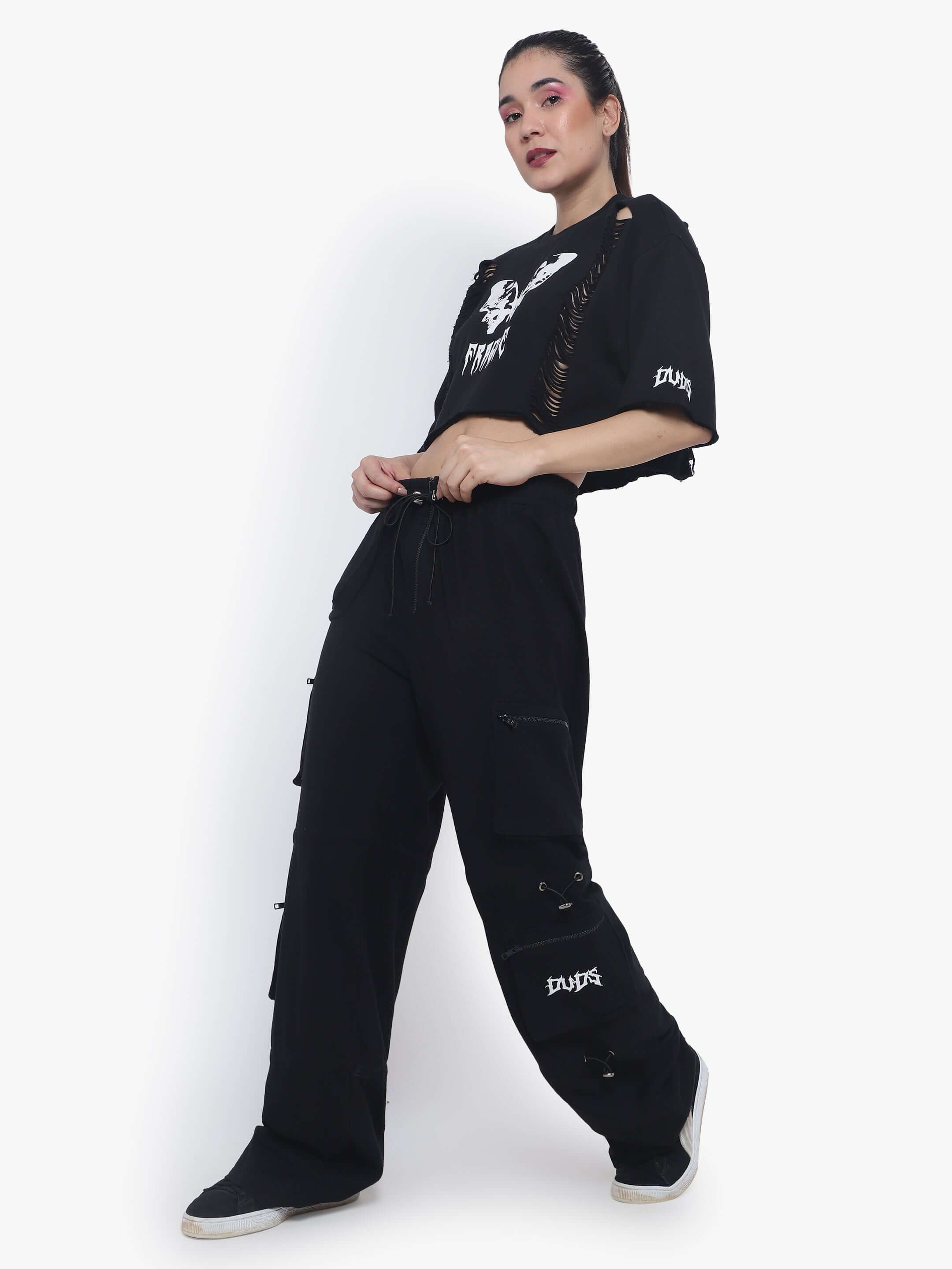 Model wearing black oversized cropped t-shirt, premium cotton, with relaxed-fit pants; styled for a casual look.