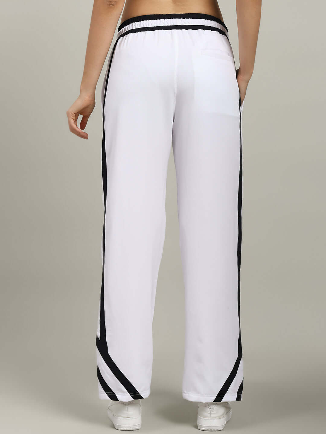 Back view of WOMEN'S FRIZZLE RELAXED FIT JOGGER WHITE with black stripe details, showcasing a comfortable and tailored fit.