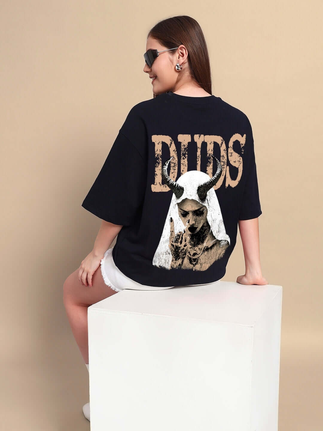 Model wearing WOMENS HORNED FIGURE CREATIVE PRINT OVERSIZED T-SHIRT BLACK with streetwear style graphics.