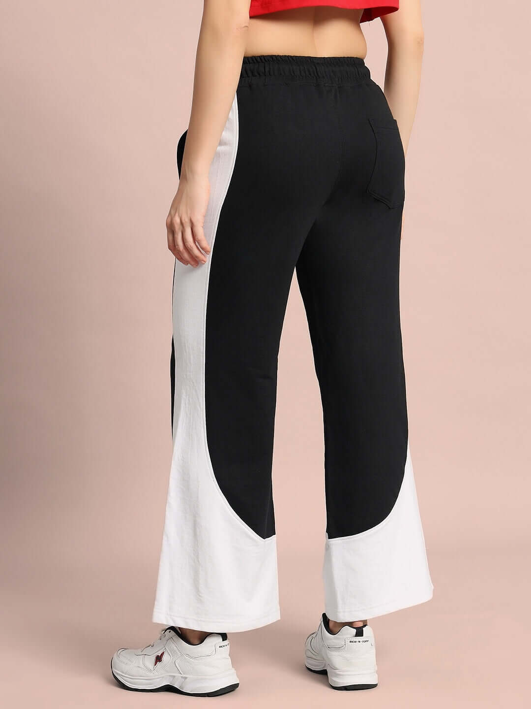 Back view of WOMEN'S HURTLE BAGGY JOGGERS in black and white worn by model.