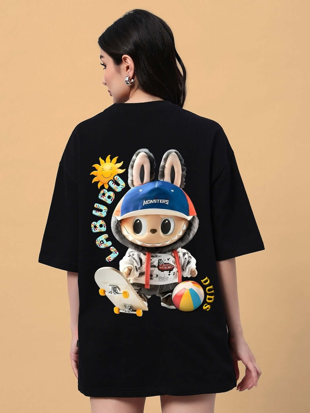 Back view of woman wearing oversized black t-shirt with Labubu monster graphic, featuring a skateboarding theme, ideal for trendy summer style.