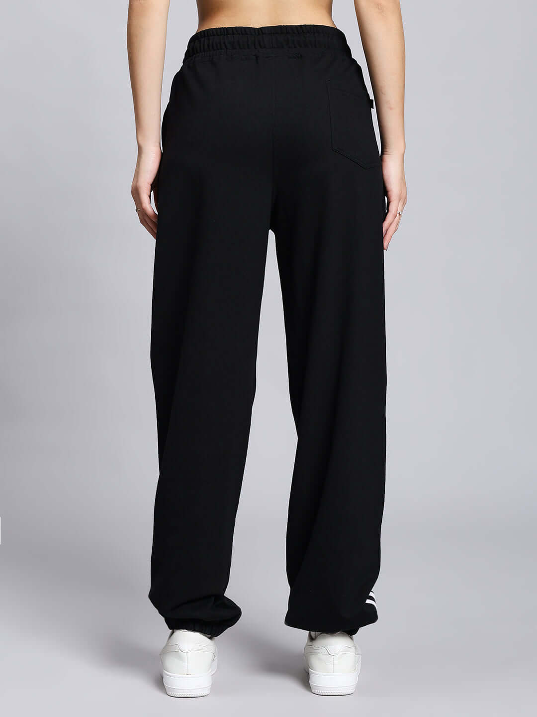 Back view of Women's Megastar 2 Stripe Jogger in black, showcasing durable, comfortable design with elastic waistband and rear pocket.