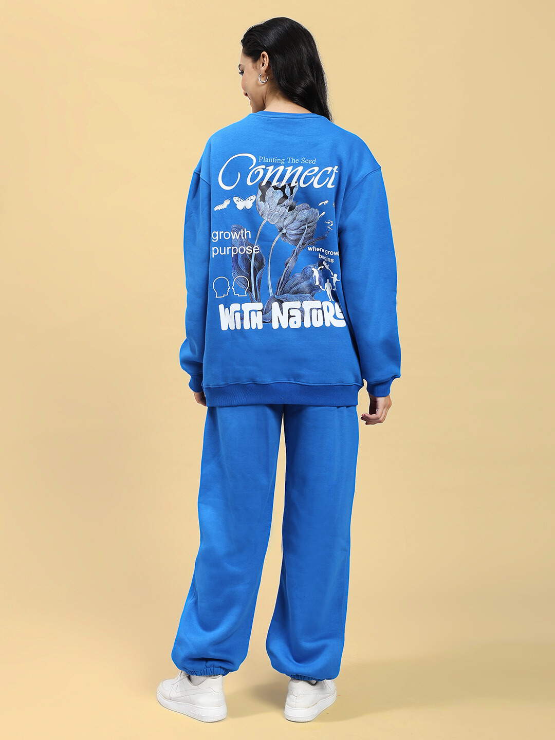 Rear view of model wearing WOMEN NATURE LINK FLEECE CO-ORD SET ROYAL BLUE with nature-inspired back design, showcasing vibrant color.