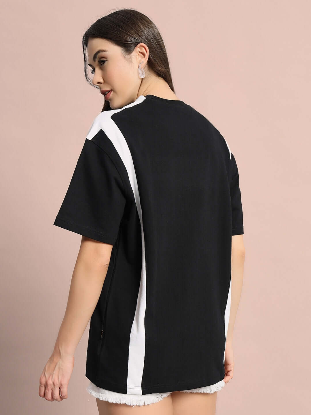 Model wearing Women's Ninja Storm oversized black t-shirt, made from premium cotton French terry, showcasing back view and fabric detail.