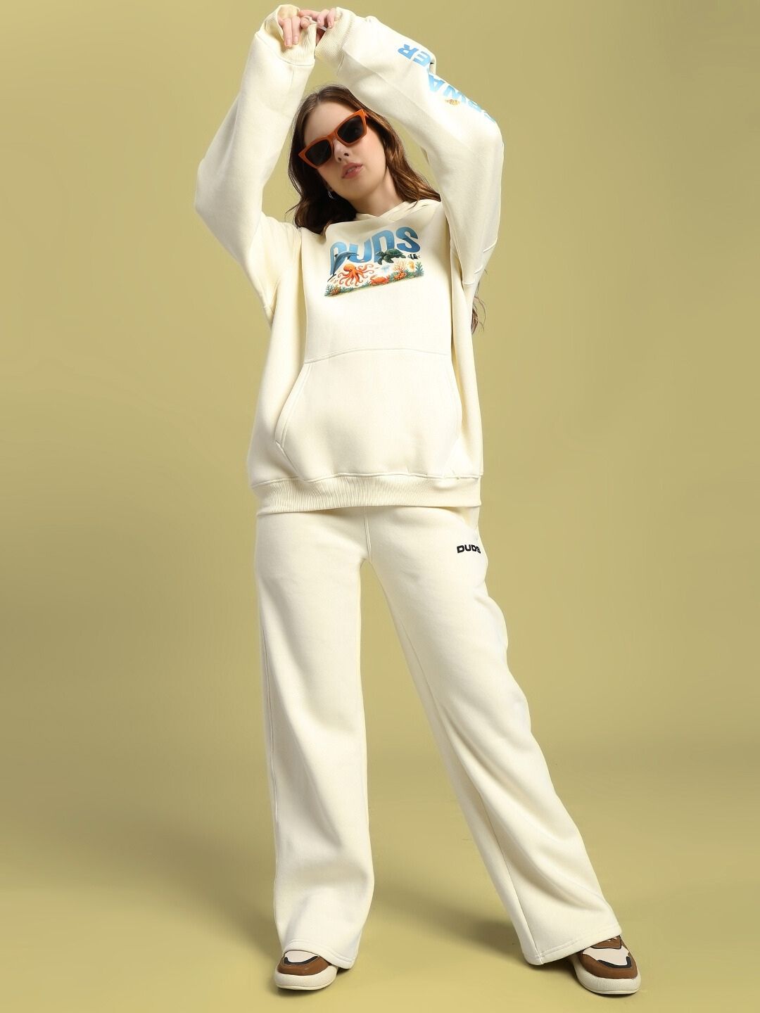 Woman modeling WOMEN'S OCEAN BUDDIES JOGGER OFF-WHITE with ocean-themed graphic.