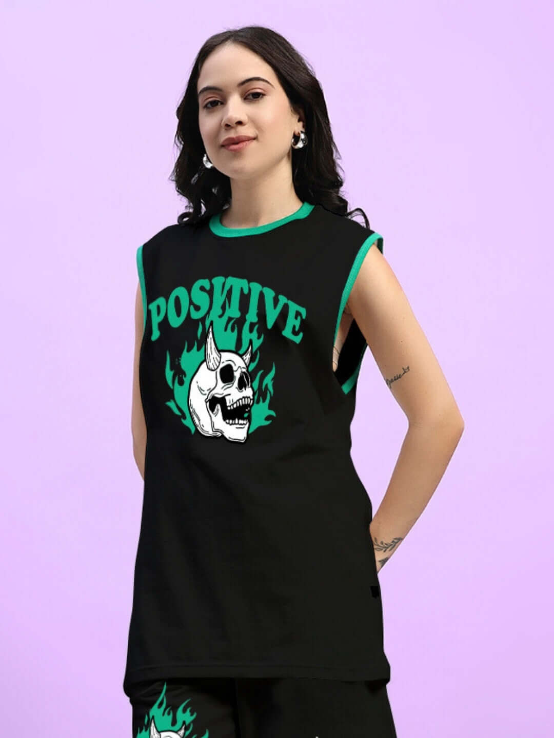 Woman wearing a black oversized t-shirt with 'Positive' and skull graphic, perfect for trendy summer style with casual comfort.