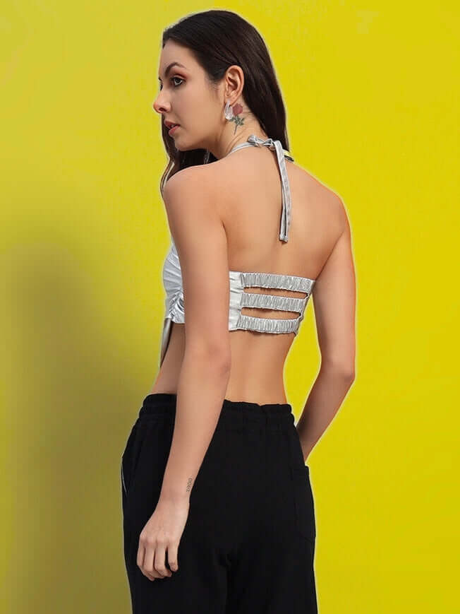 Back view of model wearing WOMEN'S REGIONAL CROP TOP SILVER displaying elegant design and metallic finish.