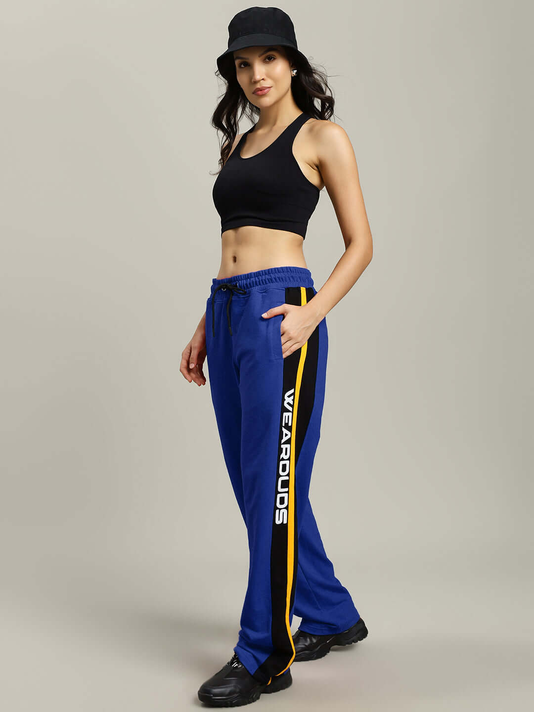 Model wearing Women's Roger Relaxed-Fit Joggers in Blue by DUDS, featuring customizable fit options and logo on side.