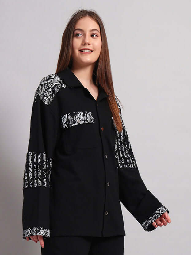 Woman wearing a black Sanganeri shirt with intricate patterns, showcasing its elegant design and comfortable fit.