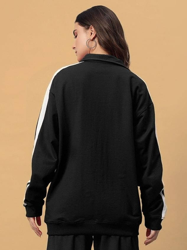 Back view of Women's Scotia Jacket in black color with white accents, worn by a model, showcasing its stylish design.