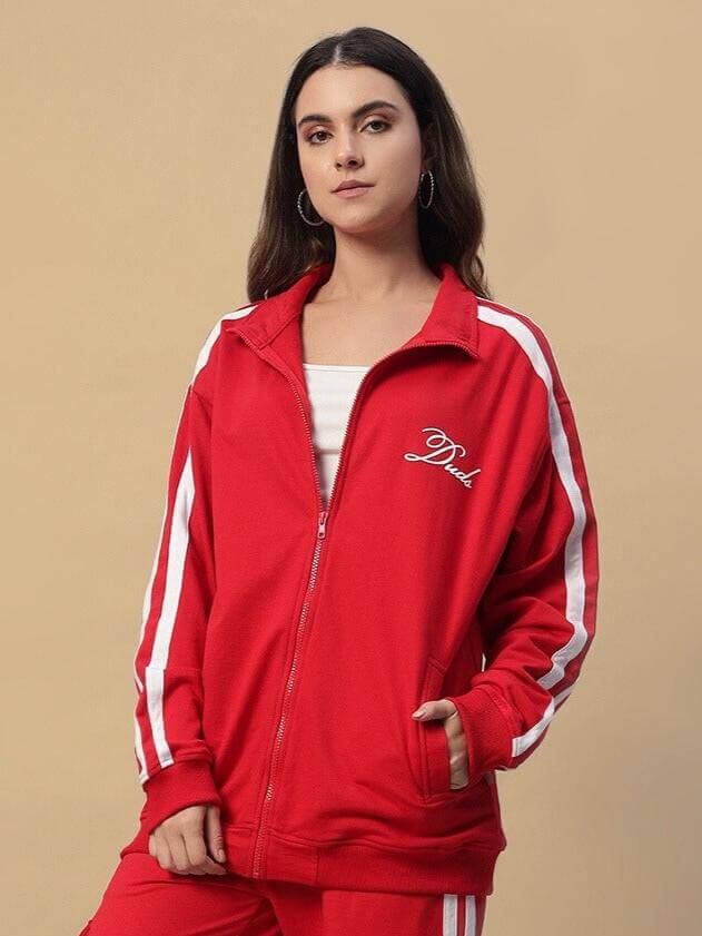 Alt Tag: Woman wearing red Women's Scotia Jacket by DUDS with white stripes, available in custom fit; experienced tailor craftsmanship.