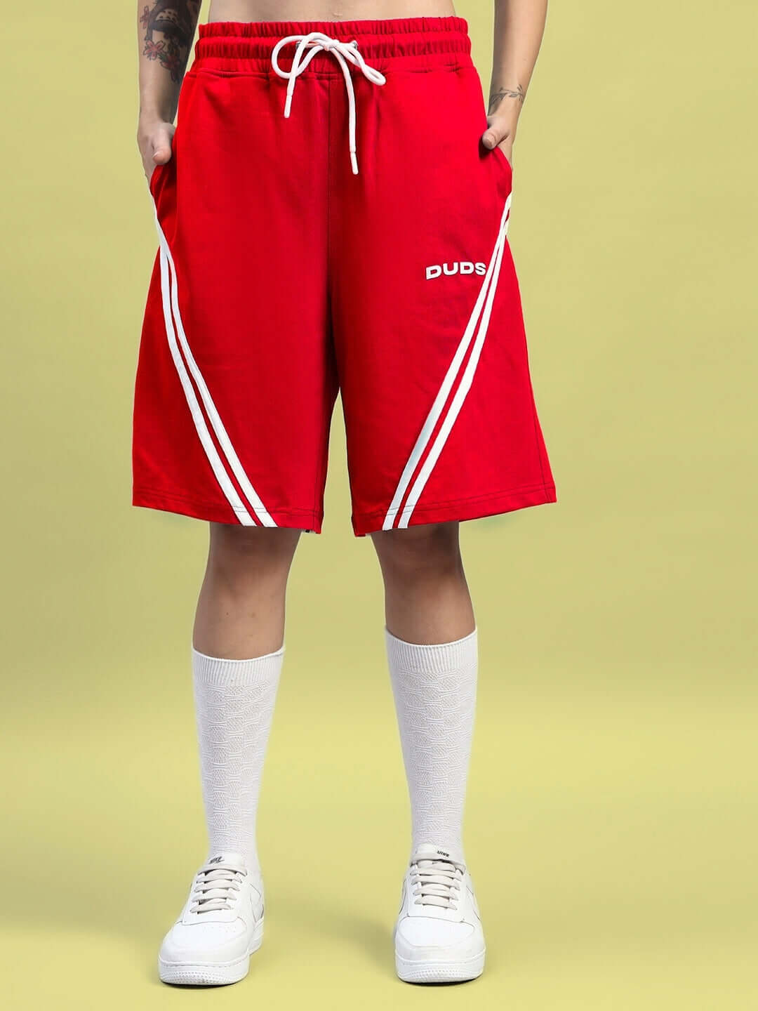 Model wearing Women's Star Jumper Red Shorts with drawstring and white stripes, regular fit, available for custom fit orders.