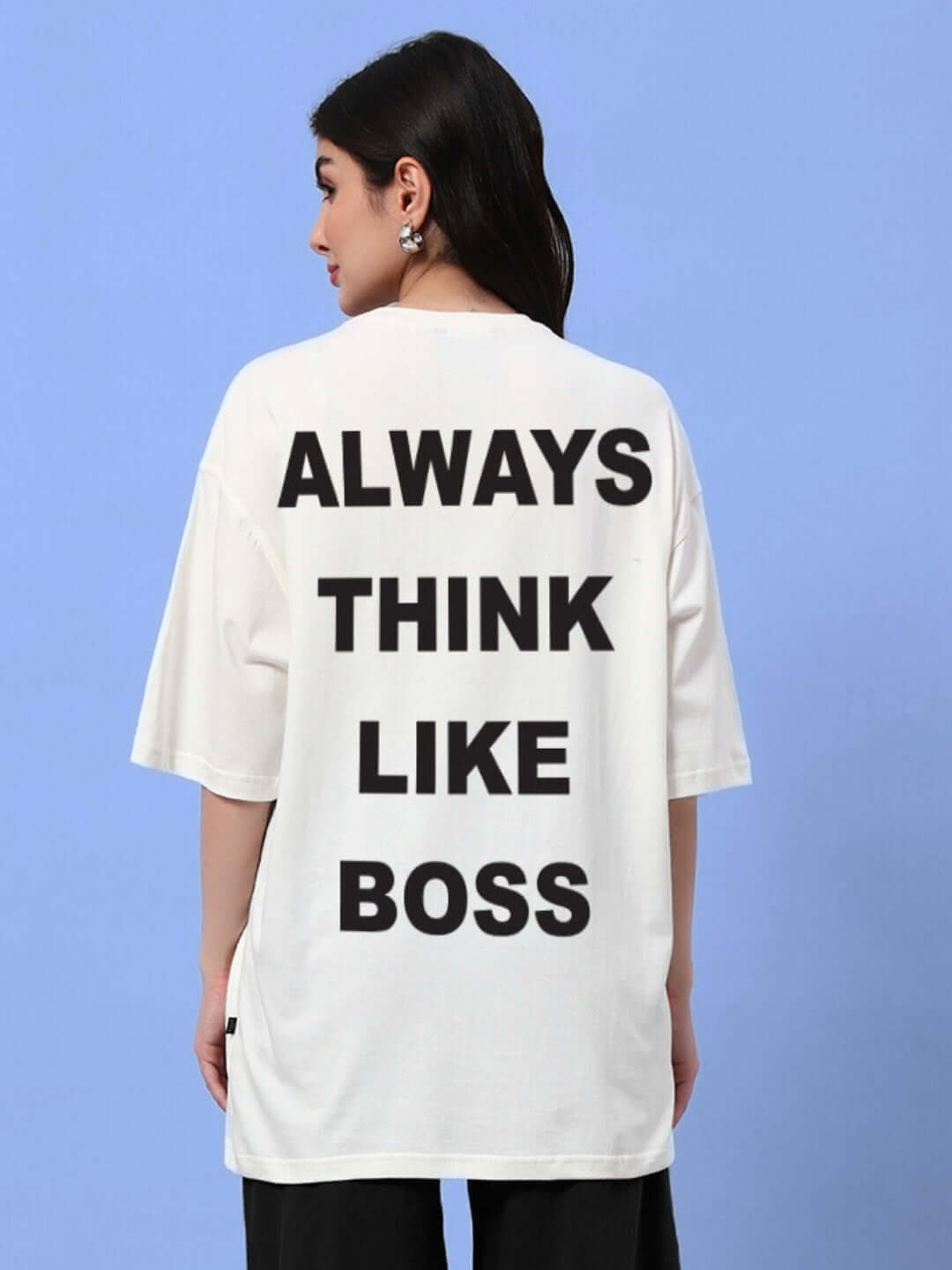 Back view of a woman wearing an oversized off-white t-shirt with 'ALWAYS THINK LIKE BOSS' text, perfect trendy summer look.