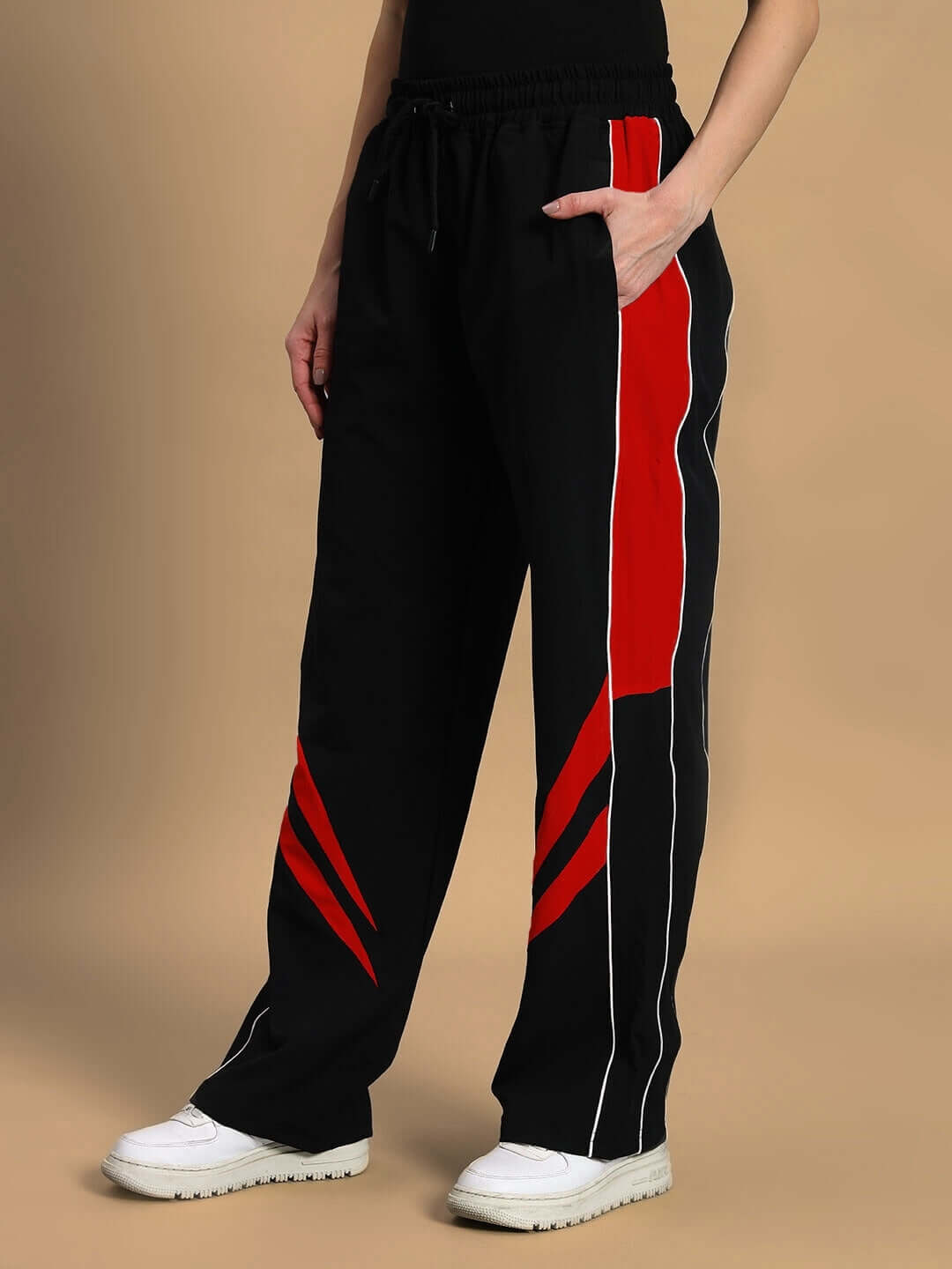Woman wearing black-red versatile parachute cargo pants with custom fit option available; ideal for unique style and comfort.