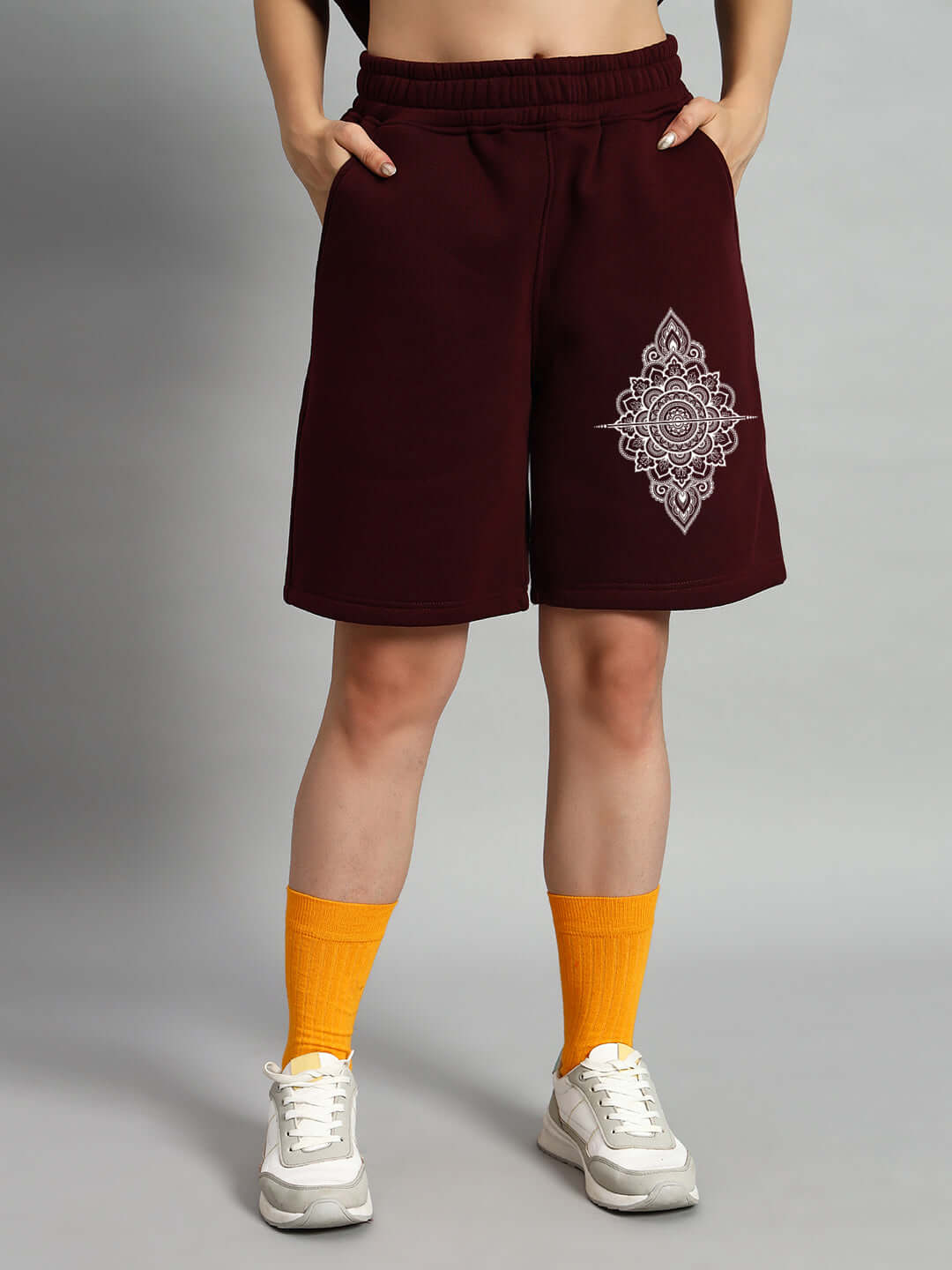 Woman wearing WOMEN'S YANTRA FLEECE SHORTS WINE with intricate yantra design.