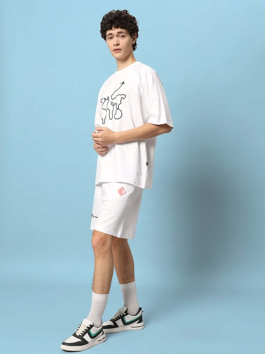 Model wearing 'The World is Mine' white printed co-ord set with premium cotton and elastane for casual style and comfort.