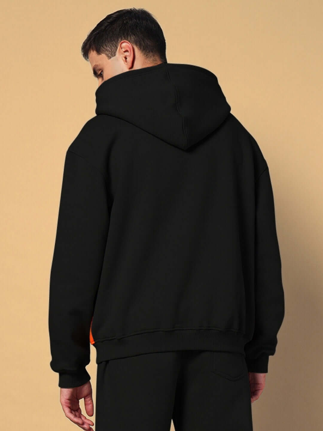 Model wearing WORLDWIDE FLEECE HOODIES BLACK showcasing back view of premium black fleece hoodie
