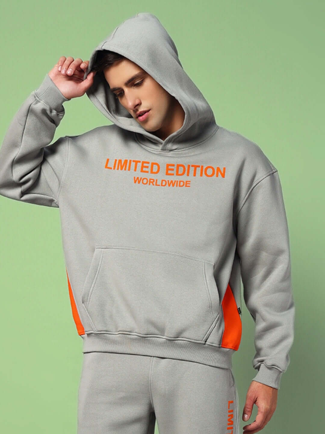 Stylish WORLDWIDE FLEECE COLORBLOCK CO-ORD GREY hoodie with orange accents on a man, showcasing urban streetwear fashion.