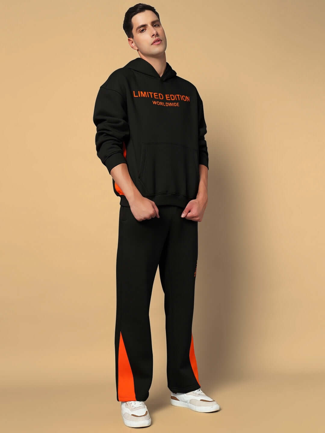 Man wearing WORLDWIDE FLEECE HOODIES BLACK showcasing premium fleece hoodie with contemporary streetwear style in black and orange accents.
